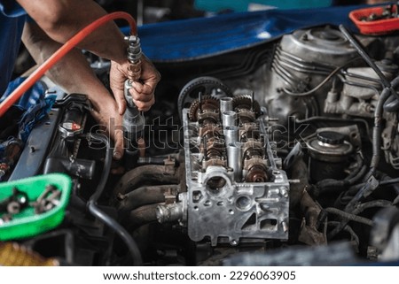 Car engine repair and service in garage service shop.