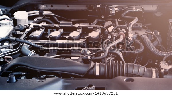 Car engine service concept - Close\
up new car engine room on checking engine maintenance service in\
car service center with flare light effect and copy\
space
