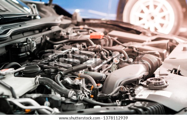 Car and engine\
service concpet - Blurred car engine room checking maintenance\
sevice by mechanical with flare light effect and copy space, Use\
for car engine service\
content