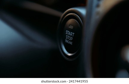 Car engine start button black and white close-up with blurred background. Close up engine car start button. Start stop engine modern new car button.