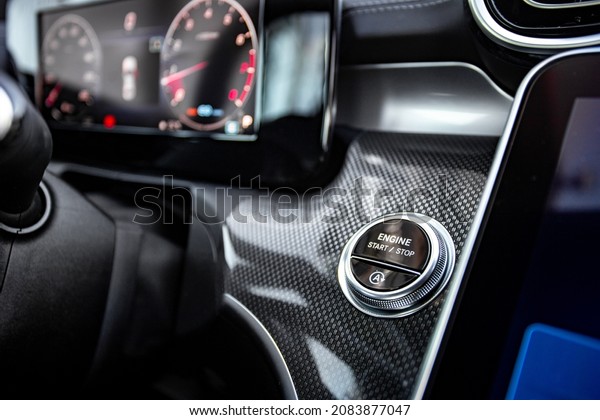 Car engine start button black and white\
close-up with blurred\
background