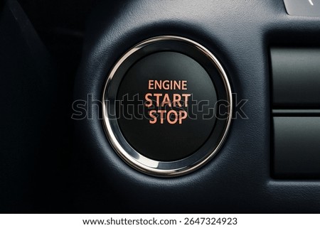 Car engine start stop button close-up, push to start ignition system, modern vehicle dashboard detail, automotive interior, luxury car feature, black button with chrome ring