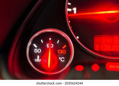 Car engine temperature sensor close up arrows.Lit red sign Overheating or norm,standart of the motor on the dashboard of the car close up.Blurred image. - Shutterstock ID 2035624244