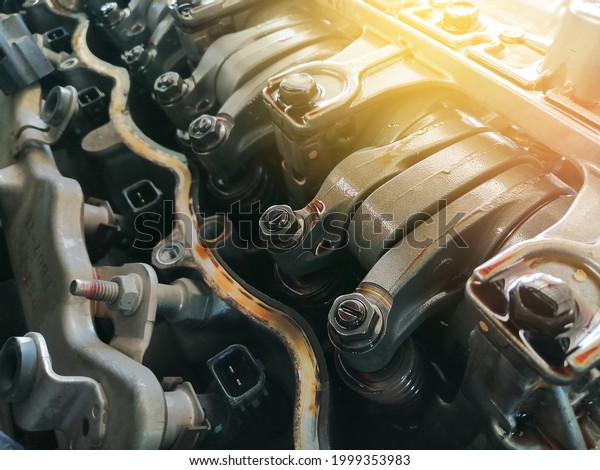 Car engine valve in the engine is open for\
adjustment in the repair\
garage