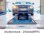 A car enters the inspection lane at the car technical inspection station. Technical inspection of the car in the workshop.