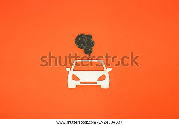 Car and exhaust gases on an orange background.\
air pollution