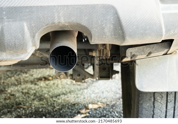 Car exhaust, gray car, the inside of the\
pipe is black soot caused by the combustion of the engine to help\
drain gas from the machine.  parked\
cars.