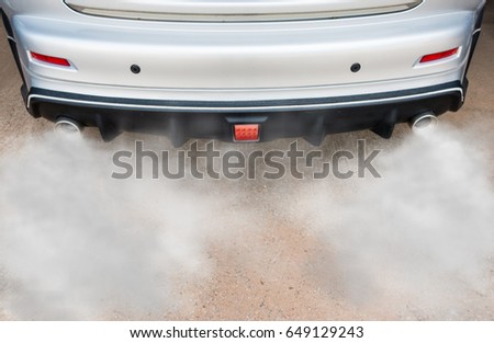 Car exhaust pipe comes out strongly of smoke, air pollution concept.