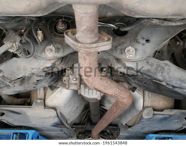 car\
exhaust pipe system at repair service\
station.