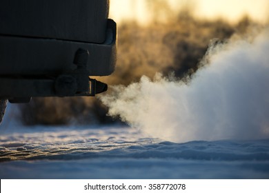 Car exhaust pipe, which comes out strongly of smoke in Finland. Focal point is the center of the photo. Background out of focus. 