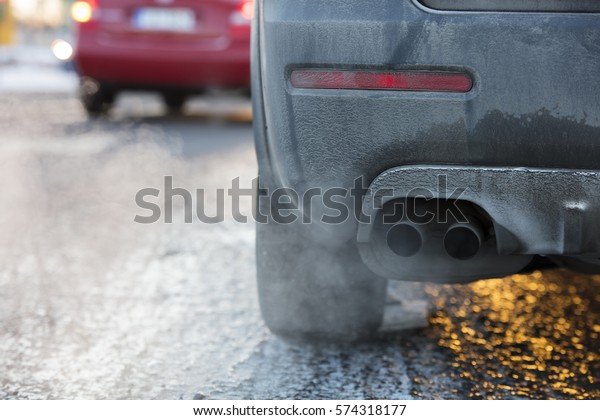 Car exhaust pipe,\
which comes out strongly exhaust gases in Finland. It is winter and\
the car is very dirty.