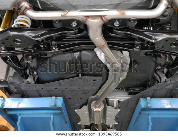 car exhaust\
system at repair service station.\
