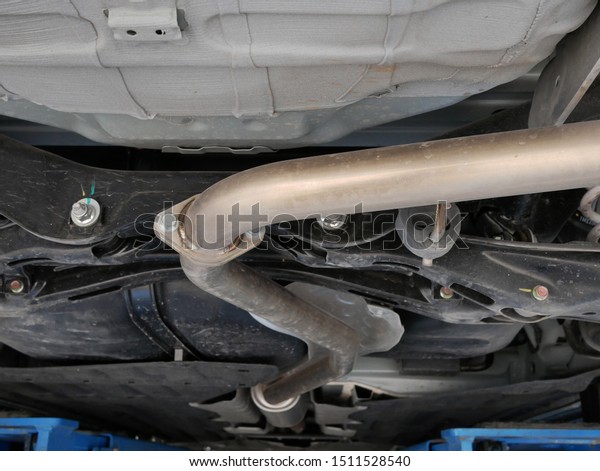 car exhaust\
system at repair service station.\
