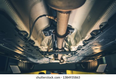 Car Exhaust System Repair. Vehicle On A Lift Awaiting Service. Automotive Industry Theme.