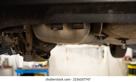 Car Exhaust System, View From On The Bridge At A Auto Repair Service. Car Underneath.