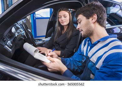 Car expert shows the checklist of repaired items to customer in garage - Powered by Shutterstock