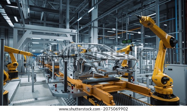 Car
Factory 3D Concept: Automated Robot Arm Assembly Line Manufacturing
High-Tech Green Energy Electric Vehicles. Automatic Construction,
Building, Welding Industrial Production
Conveyor.