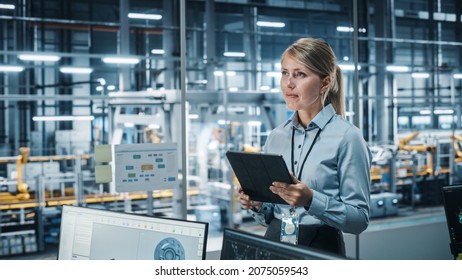 Car Factory Office Concept: Portrait Of Successful Female Chief Automotive Engineer Using Tablet Computer To Design And Optimize Automated Robot Arm Assembly Line Manufacturing Electric Vehicles