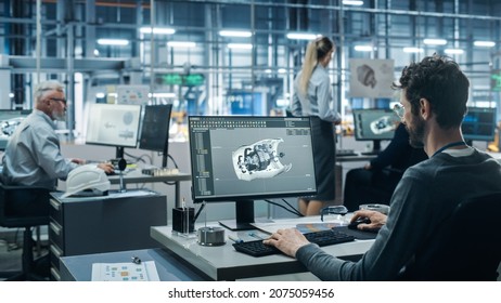 Car Factory Office: Engineer Working on Turbine Prototype on Computer, Design Advanced 3D Model for High-Tech Green Energy Electric Engine. Diverse Team Work in Automated Manufacturing Facility