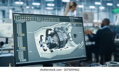 Car Factory Office: Engineer Working On Turbine Prototype On Computer, Design Advanced 3D Model For High-Tech Green Energy Electric Engine. Automated Robot Arm Assembly Line Manufacturing Facility