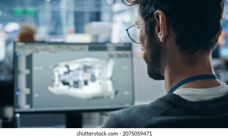 Car Factory Office: Engineer Working On Turbine Prototype On Computer, Design Advanced 3D Model For High-Tech Green Energy Electric Engine. Diverse Team Work In Automated Manufacturing Facility