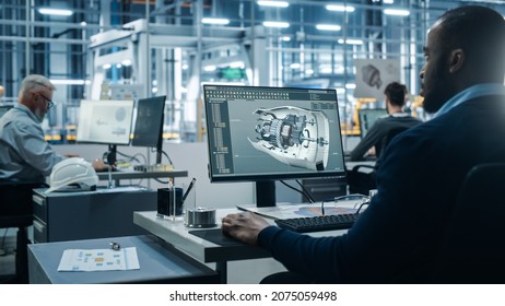 Car Factory Office: Engineer Working On Turbine Prototype On Computer, Design Advanced 3D Model For High-Tech Green Energy Electric Engine. Diverse Team Work In Automated Manufacturing Facility