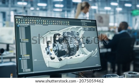 Car Factory Office: Engineer Working on Turbine Prototype on Computer, Design Advanced 3D Model for High-Tech Green Energy Electric Engine. Automated Robot Arm Assembly Line Manufacturing Facility
