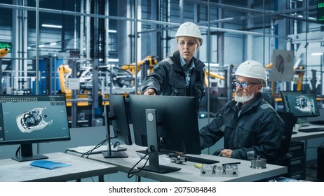 Car Factory Office: Female Manager Talks to Male Automotive Engineer Working on Computer. Automated Robot Arm Assembly Line Manufacturing Electric Vehicles. Technicians Monitoring Conveyor Production - Shutterstock ID 2075084848