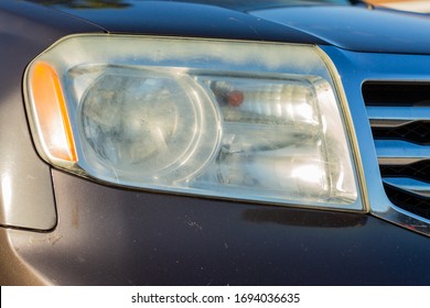 Car With Faded Headlight And Chipping Paint. 