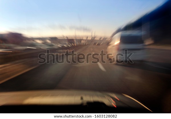 car in fast motion\
on a blurred background