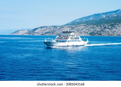 Car ferry boat in Croatia linking the island Rab to mainland passing by on adriatic sea.