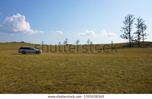 \
The car is in the field to take the lake.\
Camping. Lake Baikal,\
steppe.