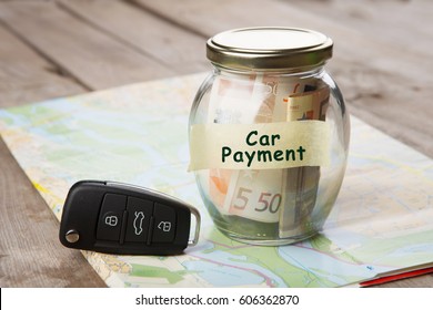 Car Finance Concept - Money Glass With Word Car Payment, Car Key And Roadmap