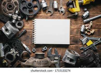 Car fix list template. Car spare parts and blank page notepad on brown wooden flat lay table background. - Powered by Shutterstock