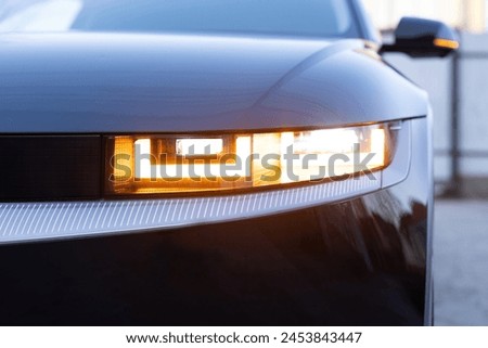 Car flashing light with blinking indicator. Emergency flashing car light lamp, warning sign. LED Headlight of a car Shining. Led light of a car shining bright. Nobody around to help