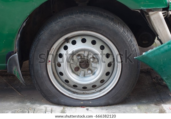 Car Flat tire and Bumper crash\
damage from accident waiting to claim with insurance company.\
