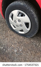 Car Flat Tire, Closeup. Car Breakdown On The Road. Tire Service.