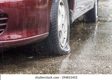 Car Flat Tire In Rainy Day