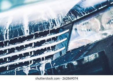 Car Foaming Closeup. Car Active Foam Cleaning Theme.