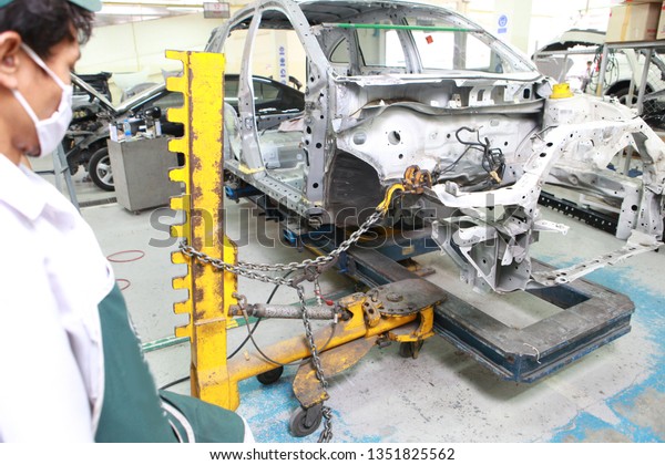 Car Frames repair Straighten\
and pulling , Repairman wearing protective equipment For work\
safety