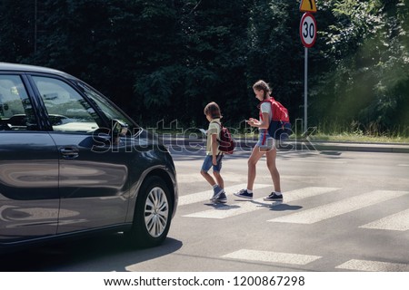 Similar – Geschwindigkeit und Kinder überqueren Straßenschild auf einer Landstraße