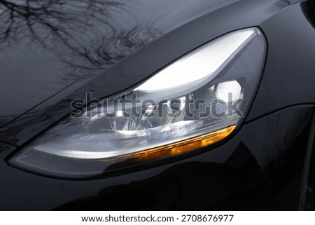 Car front full led matrix IQ Light. Modern car headlamp flashing light with blinking on continuously indicator. Switched on led matrix lights of luxury car. Car Blinker Light