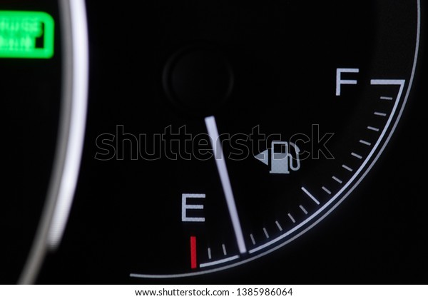 Car fuel\
indicator on dashboard close up\
view
