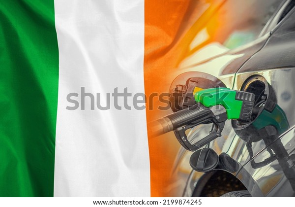Car with a fuel injector on\
Ireland flag background. Record prices fuel for population.\
Gasoline price increase during energy and fuel world crisis in\
Ireland