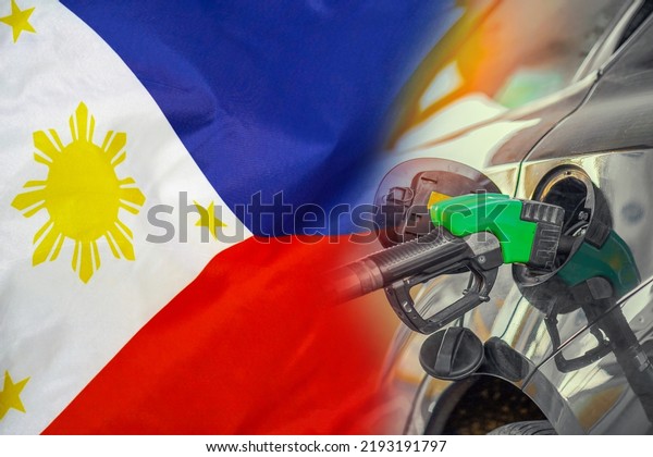 Car with a fuel injector on\
Philippines flag background. Record prices fuel for population.\
Gasoline price increase during energy and fuel world crisis in\
Philippines