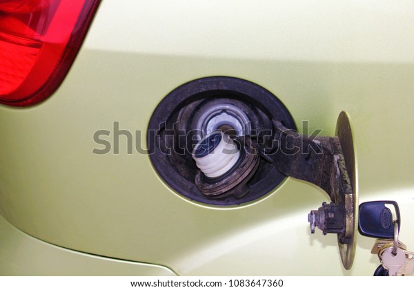 Car fuel tank. Automobile\
fuel filler cap. Opened car fuel tank. Energy concept. Fuel tank on\
auto.