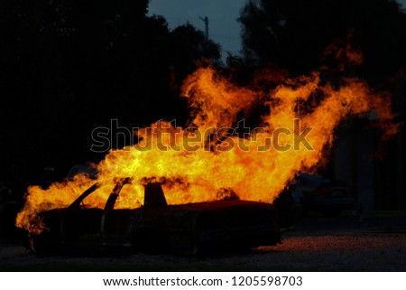A car fully engulfed in flames.