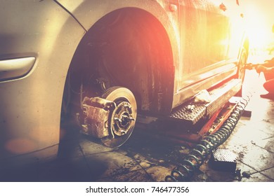 Car In Garage In Auto Mechanic Repair Service Work Shop With Special Machine Repairing Equipment, Sunlight Effect, Toned