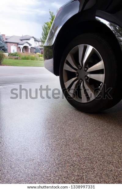 Car in\
garage with epoxy floor coating over\
concrete.