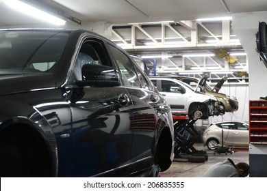 Car In Garage With Special Equipment Prepared For Repair